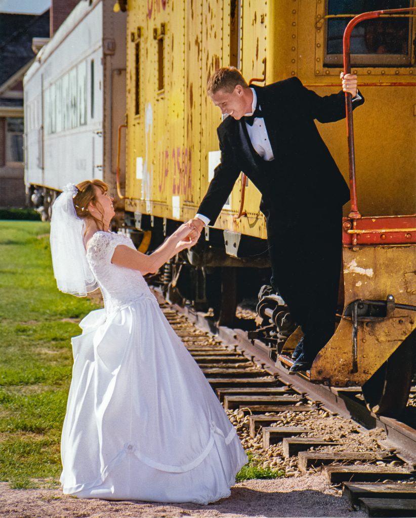wedding_2 Photo of groom on back of rail car pulling bride up from the ground